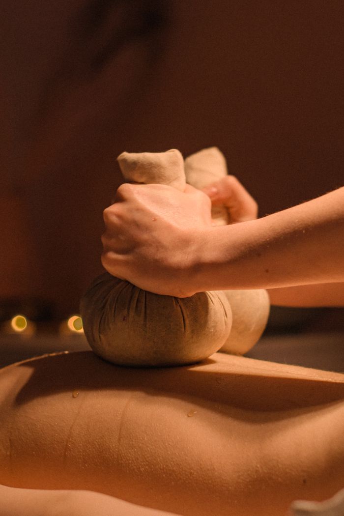 Mastering the First Impression: Your intriguing post title goes here Close-up of a soothing herbal compress massage for relaxation and rejuvenation.